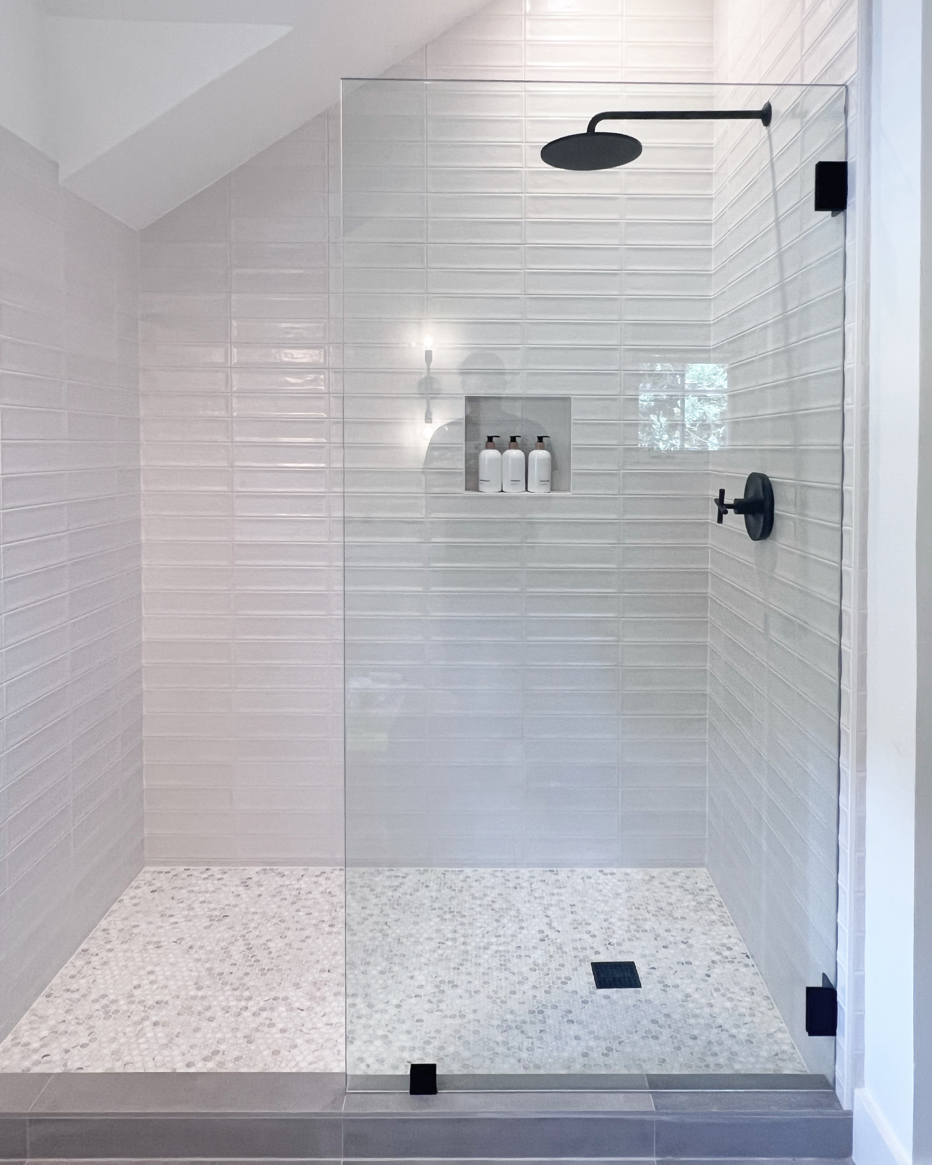White tile shower with matte black hardware