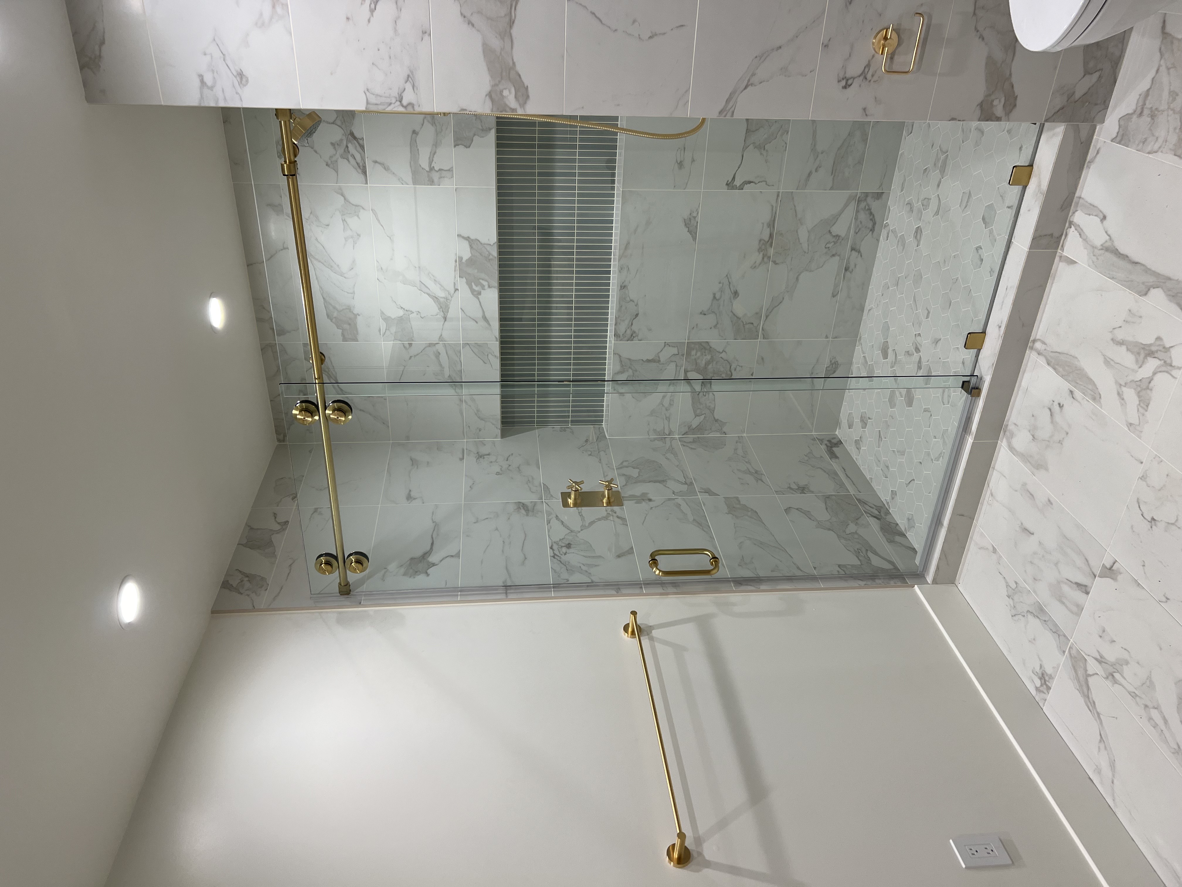 Sliding shower door with brass hardware