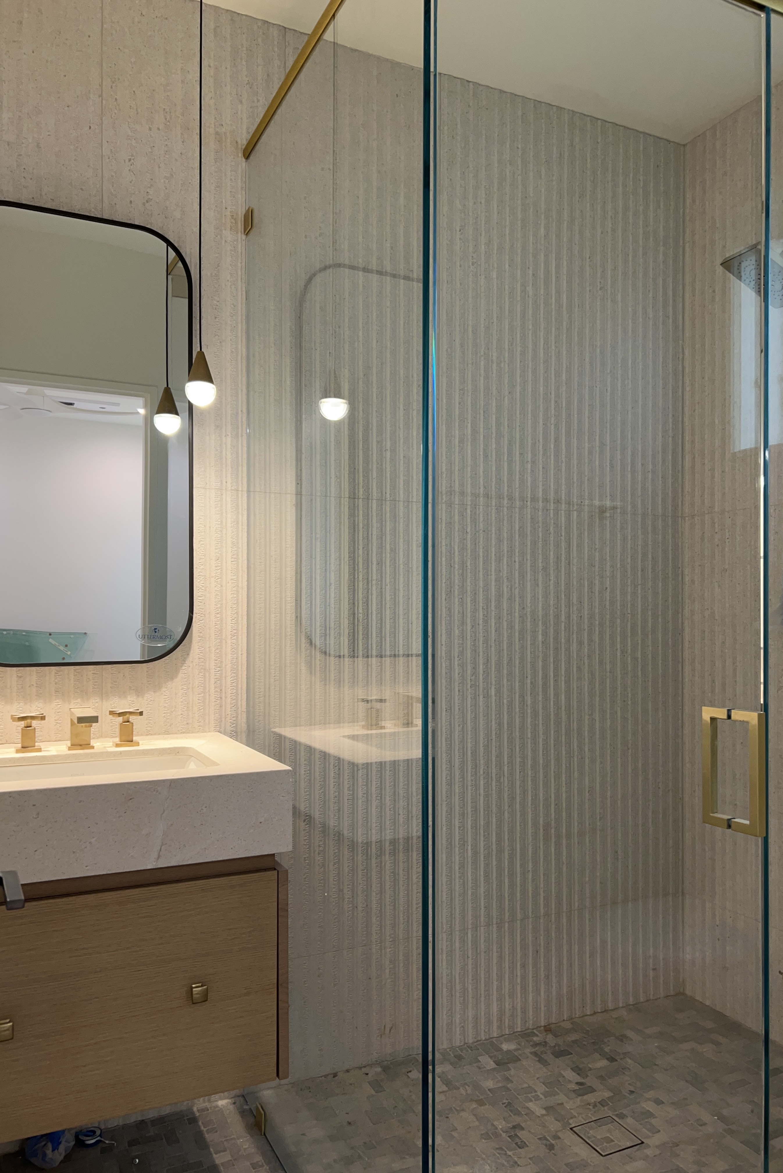 Minimal shower enclosure with brass fixtures