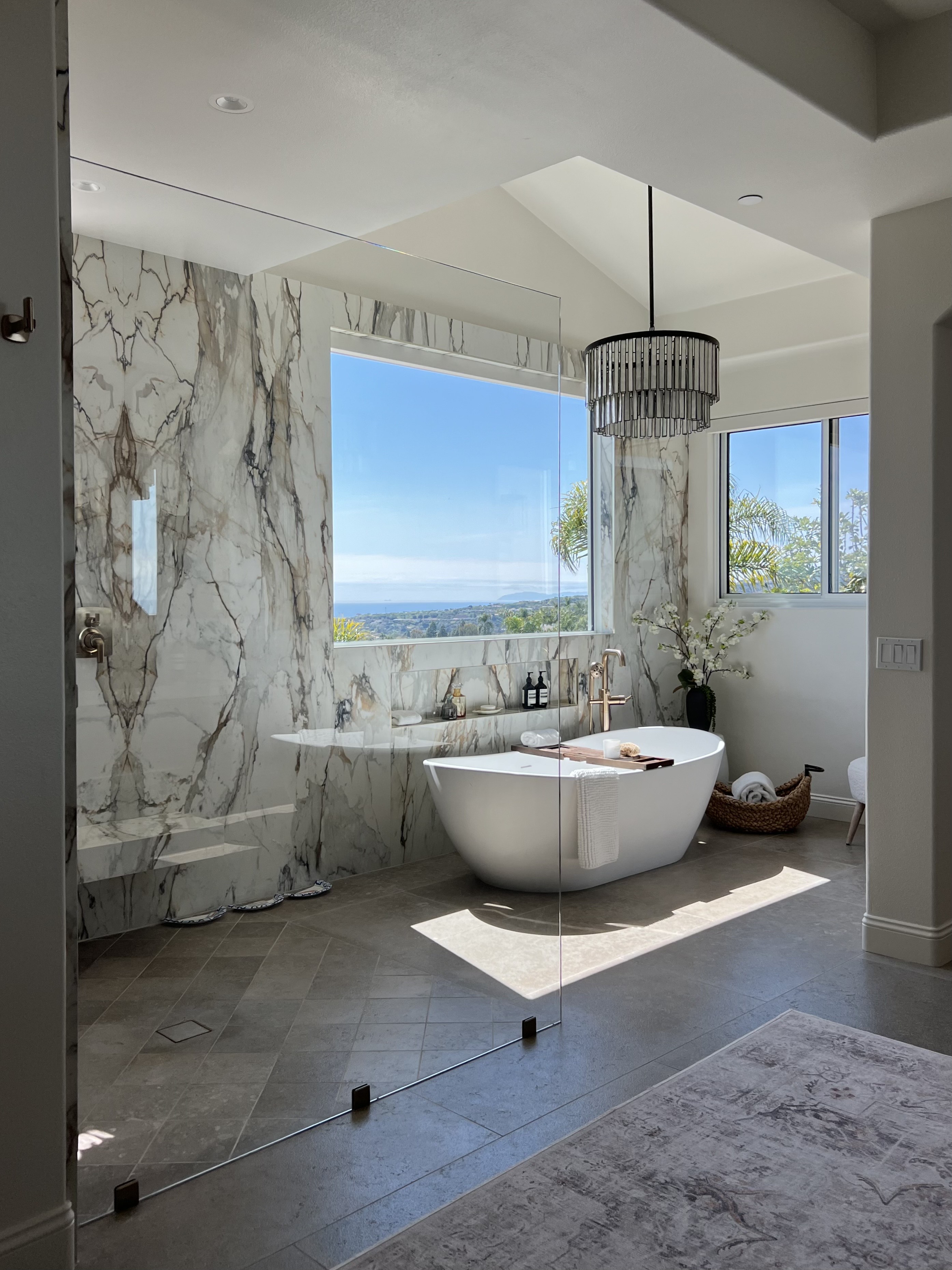 Large frameless shower with soaking tub and view